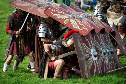 A modern recreation of soldiers fighting in the 'testudo' formation, Birdoswald, Cumbria.