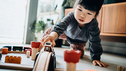 A child playing with wooden toys which have become more popular as Christmas presents in recent years