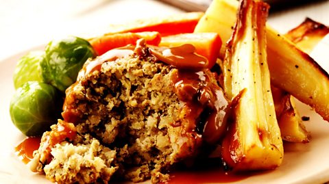 A plate of Christmas nut roast dinner which also features sprouts, carrots and parsnip