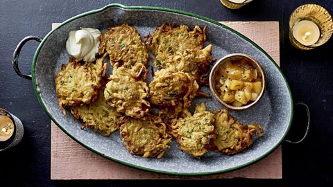 Potato and apple fritters, or latkes, with apple compote and soured cream