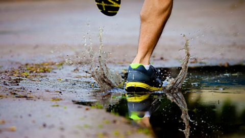 A person running through a puddle