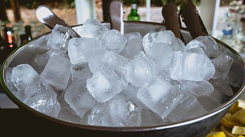 A bowl of ice cubes melting