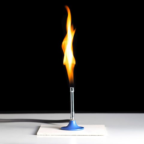 A Bunsen burner using methane to burn with a flame