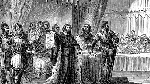 Am image of King John holding the Magna Carta surrounded by barons.