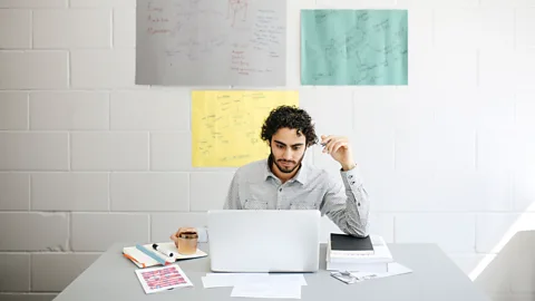 Getty Images Many US workers are worried about seeming uncommitted or like a 'slacker' if they aren't at their desks (Credit: Getty Images)