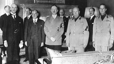 A black and white photo showing Chamberlain, Daladier, Hitler and Mussolini standing side by side at the Munich Conference, 1938.