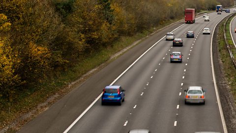 Cars travelling on a three-lane motorway.