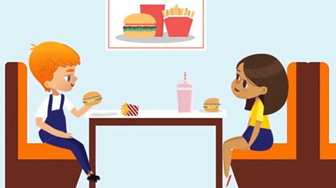 Two children eating 1970s fast food