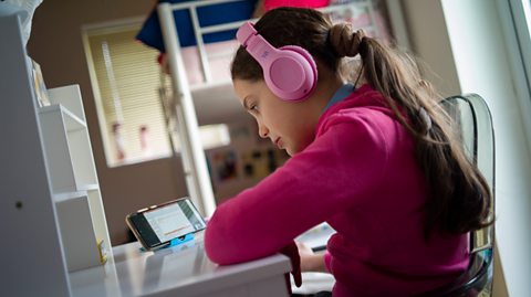 Girl using a mobile for homework