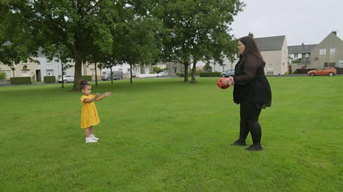 mum and daughter playing ball games in the park