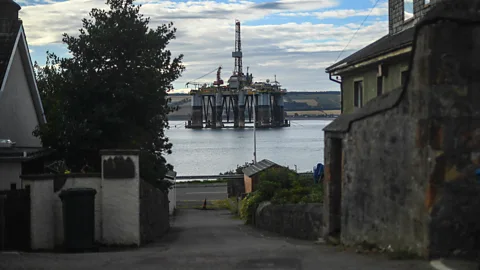 Getty Images From the dry land of a Scottish village, an oil rig can seem like an alien structure… (Credit: Getty Images)