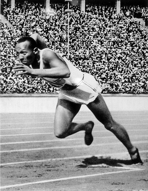 A black and white photograph of Jesse Owens running the 200m.