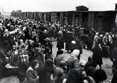 A black and white photograph of Jewish people from Hungary arriving at Auschwitz.