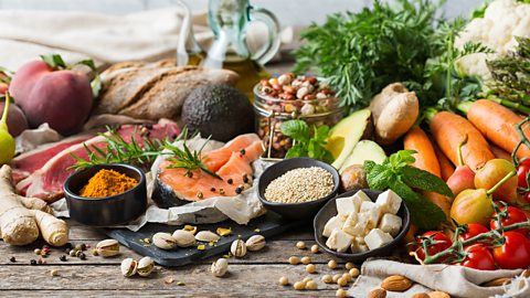 The varied foods of the Mediterranean diet including, nuts, oily fish, fruits and vegetables, olive oil, bread and lean meat.