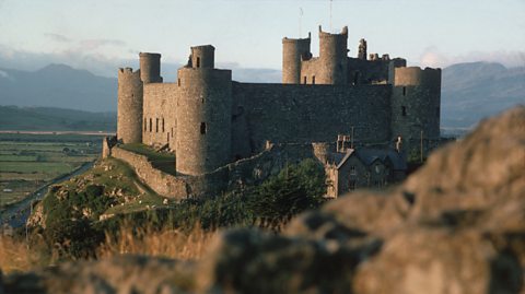 Harlech Castle, Gwynedd, Wales which stands on a crag protected by the sea on one side and a moat on the other