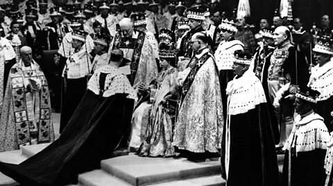 Prince Philip the Duke of Edinburgh kneels before Queen Elizabeth II during her Coronation.