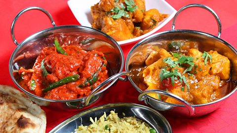 A selection of Indian curry dishes with rice and keema naan.