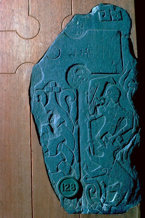 A Viking cross, showing god of war Odin with a raven and spear. 