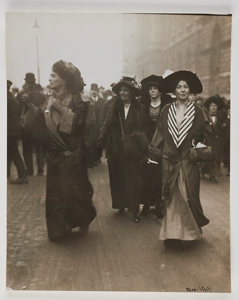 A photograph of Suffragette leaders in the street.