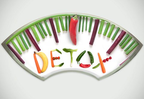 A picture of weight scales and the word detox all made out of fruit and vegetables 