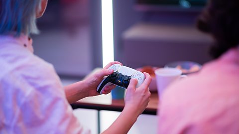 Person playing with a games controller