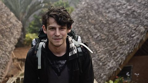 A photograph of Adam Levy wearing a backpack in Madagascar.