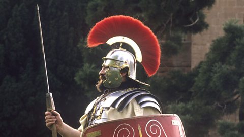 A Roman soldier re-enactor with a javelin and shield.