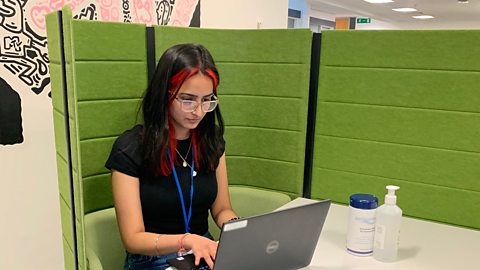 Jaskaran working on her laptop at a desk