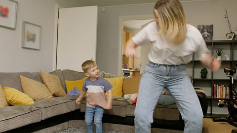 A mother and son do an angry dance in their living room.