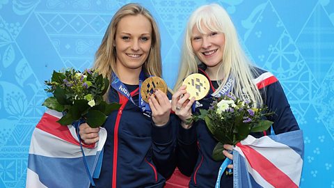 Guide Charlotte Evans and Kelly Gallagher show their gold medals in the super-G from the 2014 Winter Paralympics in Sochi.