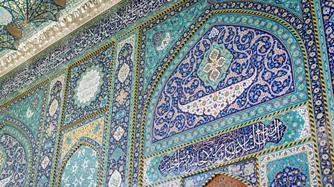 A colourful patterned wall in a mosque.