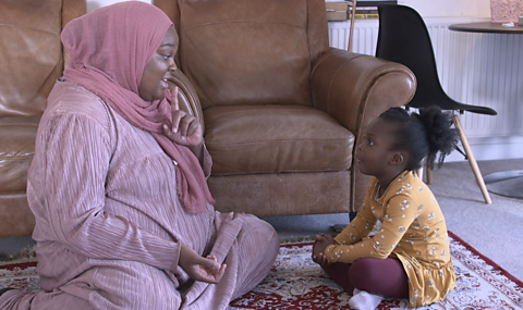 Mum and daughter sitting on their 'magic carpet' enjoying a mindful moment