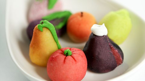A bowl of brightly coloured marzipan fruits