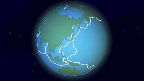 A cartoon globe with tectonic plates on its surface.