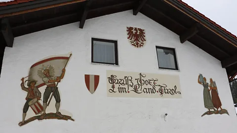 Mike MacEacheran A sign on a Jungholz farmhouse welcomes visitors to the "Land of Tirol" (Credit: Mike MacEacheran)