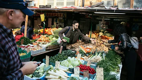Taube Jewish Heritage Tours Jeffrey Yoskowitz examines the fresh produce at a Polish market (Credit: Taube Jewish Heritage Tours)