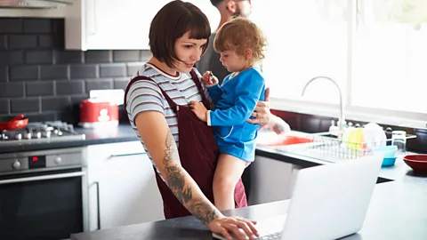 Getty Images Children may not understand why parents are splitting attention between work and care (Credit: Getty Images)