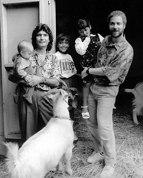 Gigi Kaeser / Love Makes a Family Rob and Jon Cooper with baby Christopher, Daniel and Jessica. They later adopted two more children, Jennifer and Kimberly (Credit: Gigi Kaeser / Love Makes a Family)