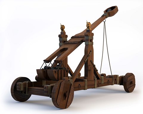 A trebuchet. It is a wooden structure on four wheels with a catapult on top. 