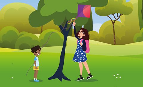 Niamh helps a child to get a kite from the tree