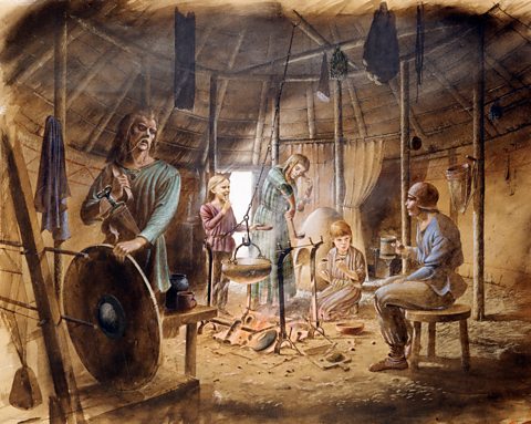 A reconstruction drawing of the interior of a roundhouse at Maiden Castle in the Iron Age, showing family life.