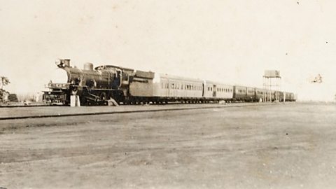 A black and white photograph of a train on the Uganda Railway.