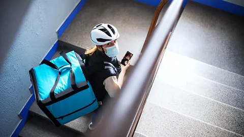 Getty A delivery worker climbing the stairs