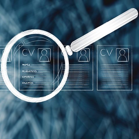 A magnifying glass over a selection of CVs. 