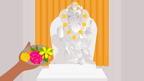 A person is offering flowers to the deity.