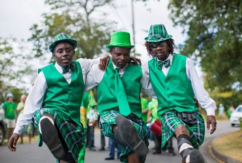 A trio wear costume kilts during the 2018 St Patrick’s parade in Monserrat