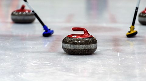 Curling stone being used in a winter sport