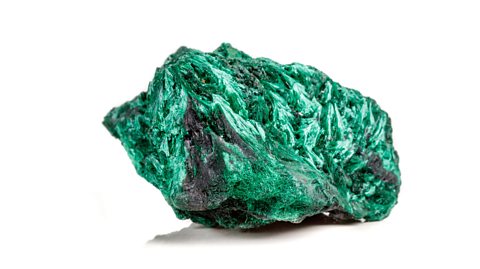 A green rock consisting of malachite, a compound of copper, carbon and oxygen