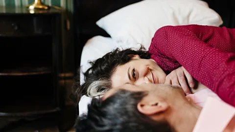 Getty A couple lying in bed together