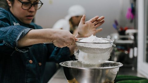 Woman sifting flour